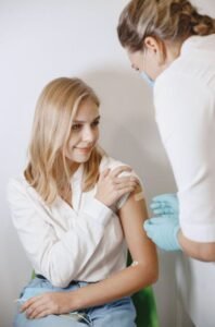 Diverse group of young girls receiving HPV vaccines at a community health clinic